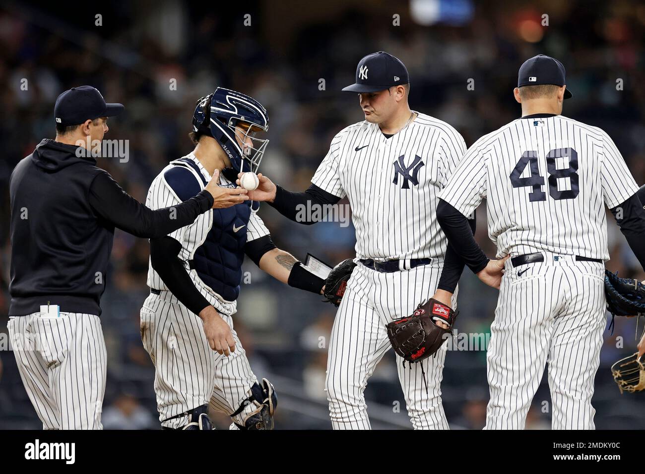 New York Yankees pitcher Sal Romano gives the ball to manager Aaron Boone  against the Toronto Blue Jays during the seventh inning of a baseball game  on Thursday, Sept. 9, 2021, in