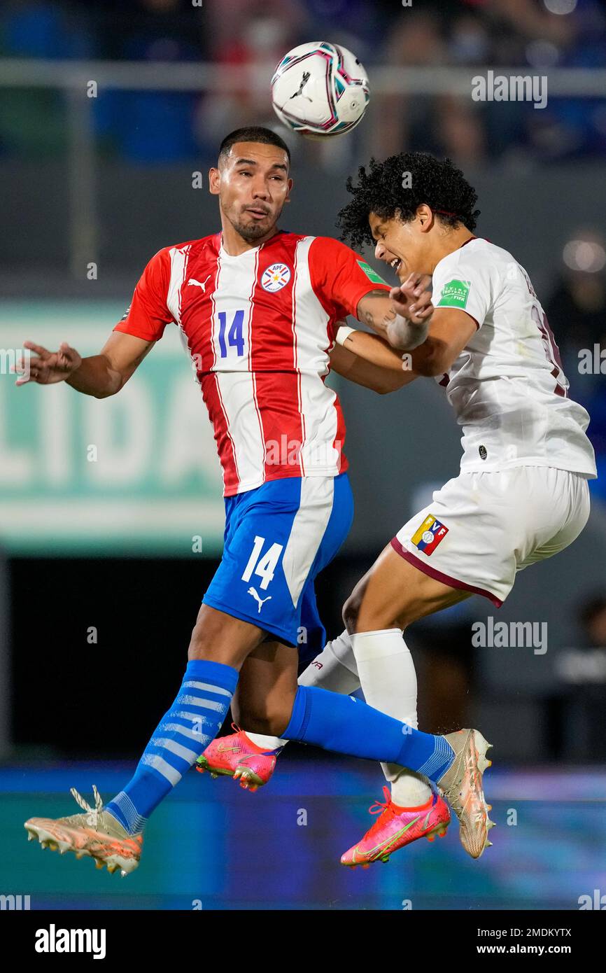 Paraguay's Hector Martinez, left, and Venezuela's Eduard Bello go for a ...