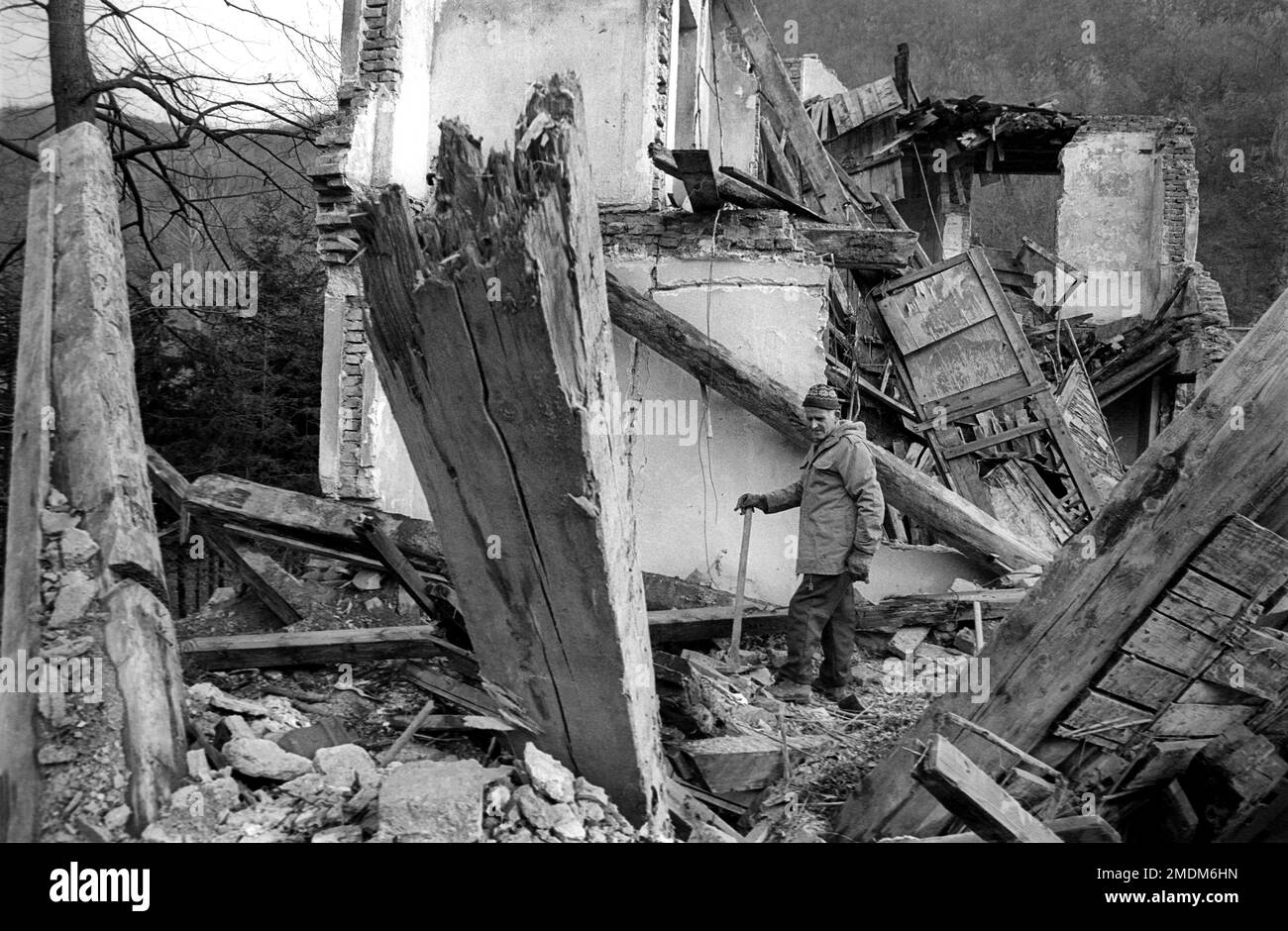 A man stands in the ruins of his house destroyed by a bomb in the civil war in Bosnia in 1994 Stock Photo