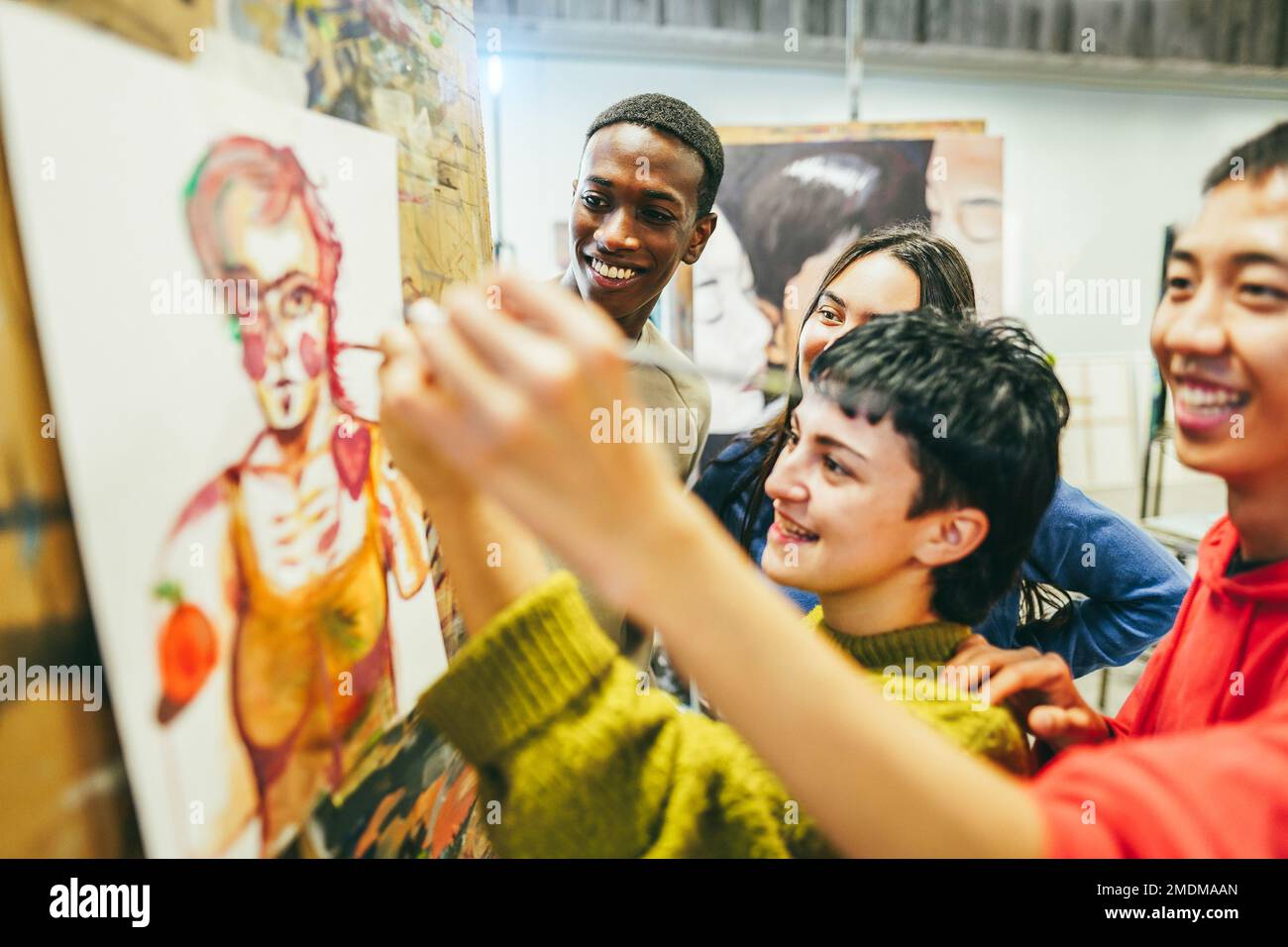 Multiracial students painting inside art room class - Focus on african guy face Stock Photo