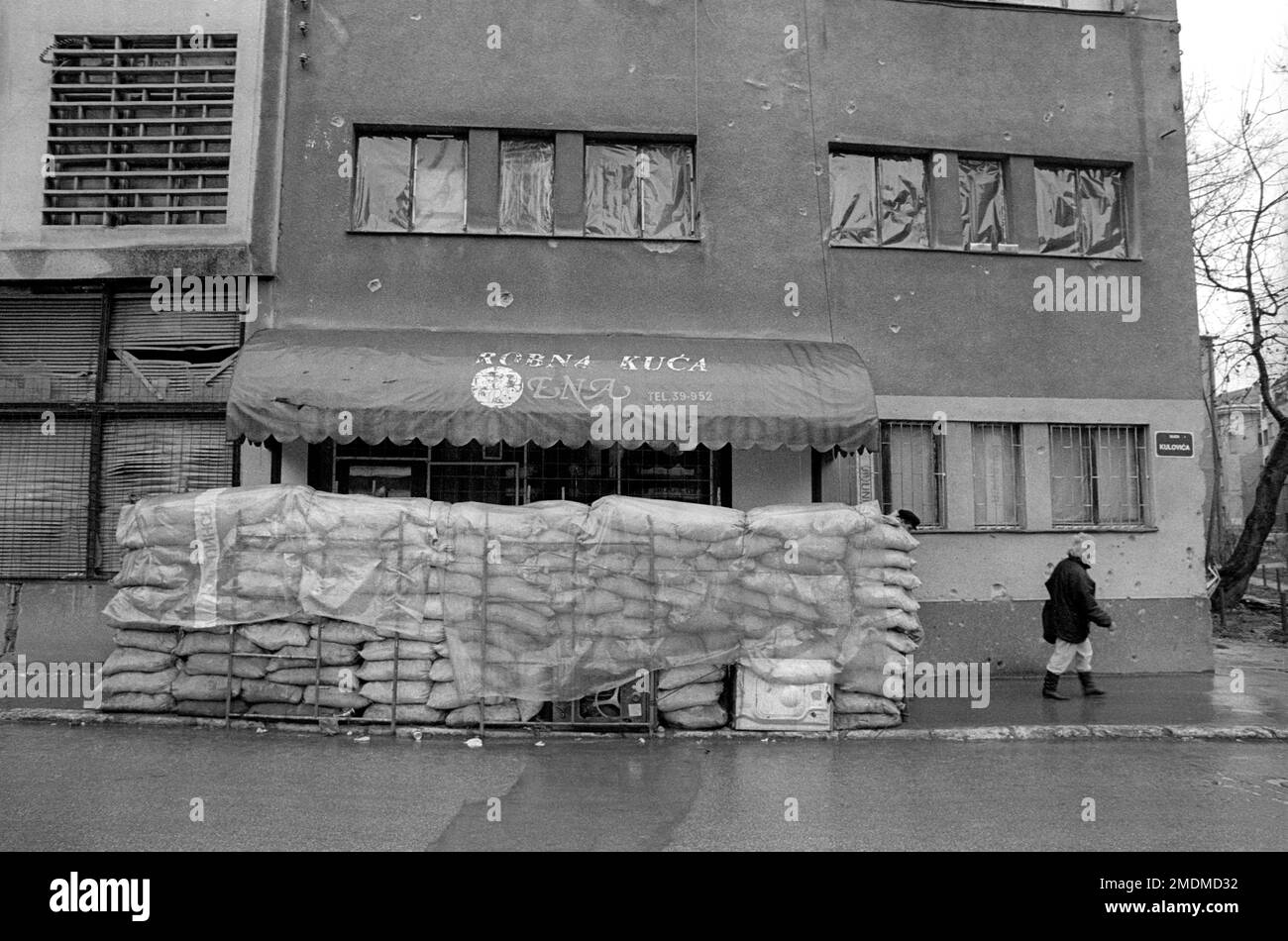 Sandbags protecting a building entrance from bomb damage during the Bosnian civil war in Sarajevo in 1994 Stock Photo