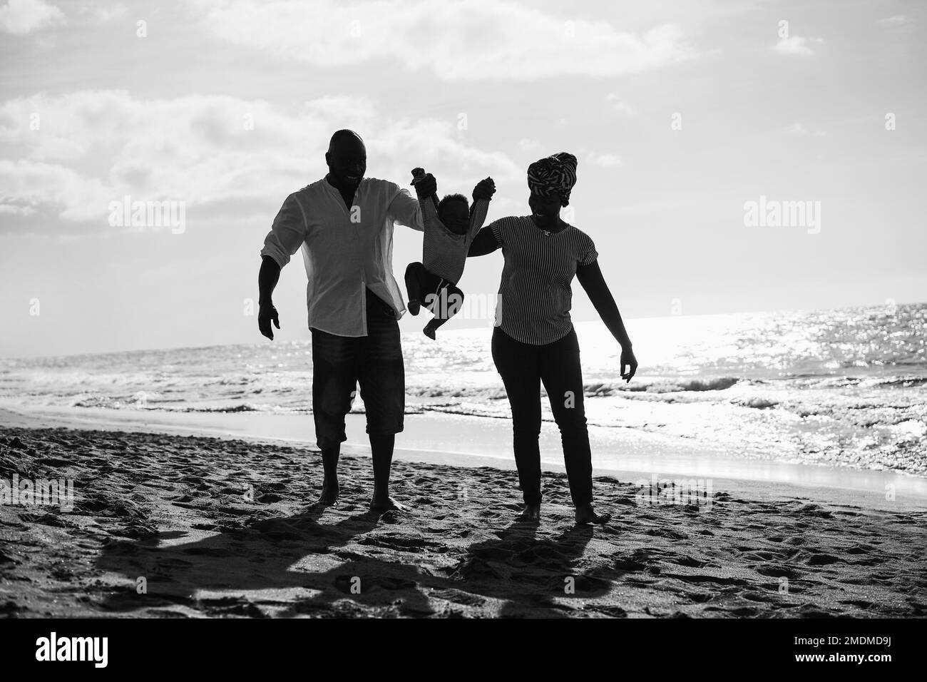 African family having fun on the beach in summer vacation - Black and white editing Stock Photo