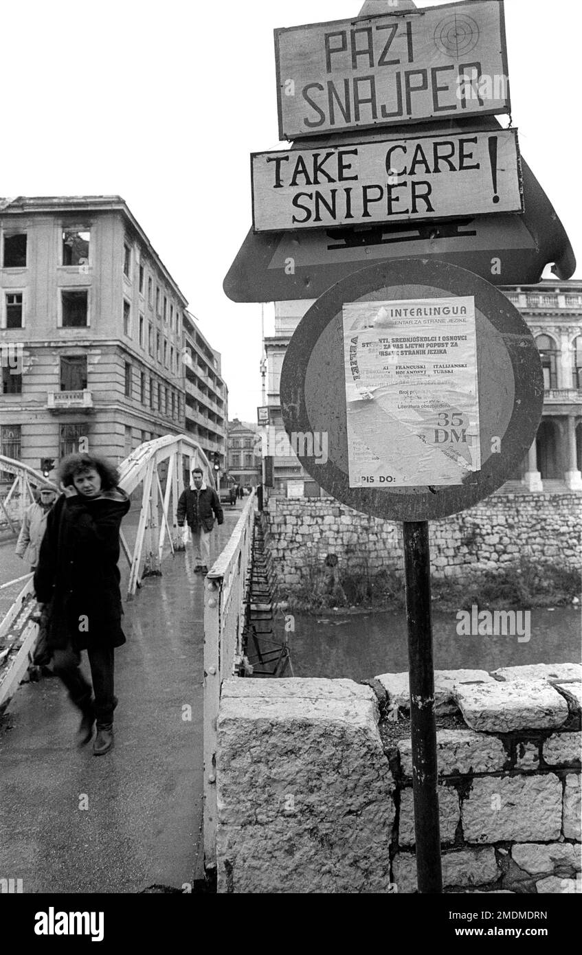 Citizens in Sarajevo cross a bridge targeted by snipers during the siege of Sarajevo in 1994 Stock Photo