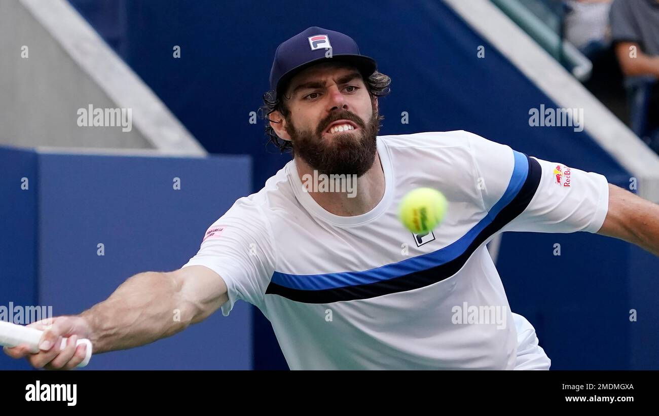 Reilly Opelka, of the United States, returns a shot against Lloyd Harris, of South Africa, during the fourth round of the US Open tennis championships, Monday, Sept
