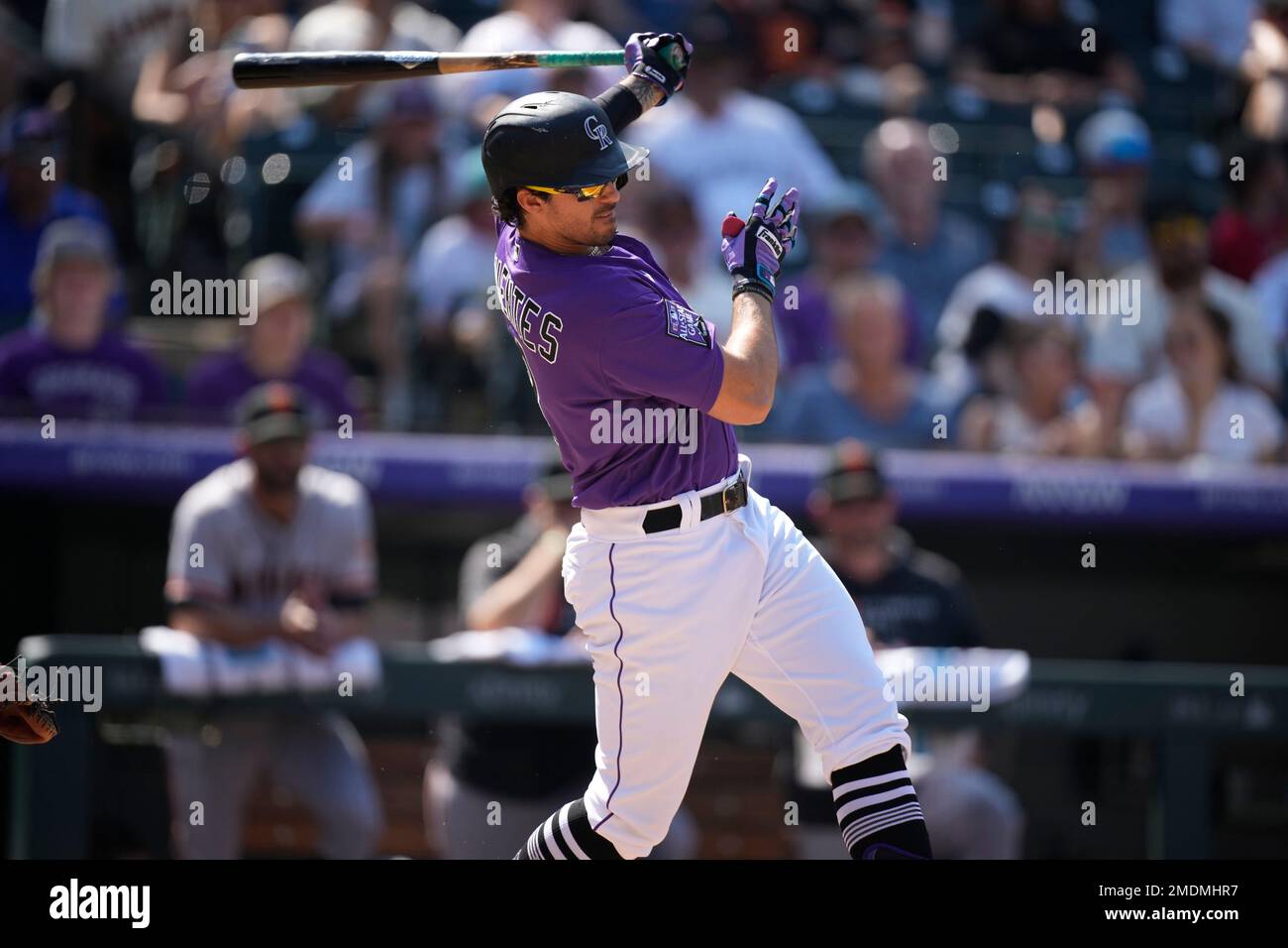 Colorado Rockies third baseman Joshua Fuentes, left, tags out Texas Rangers'  Brock Holt as he slides into third base while trying to stretch a double  into a triple in the sixth inning