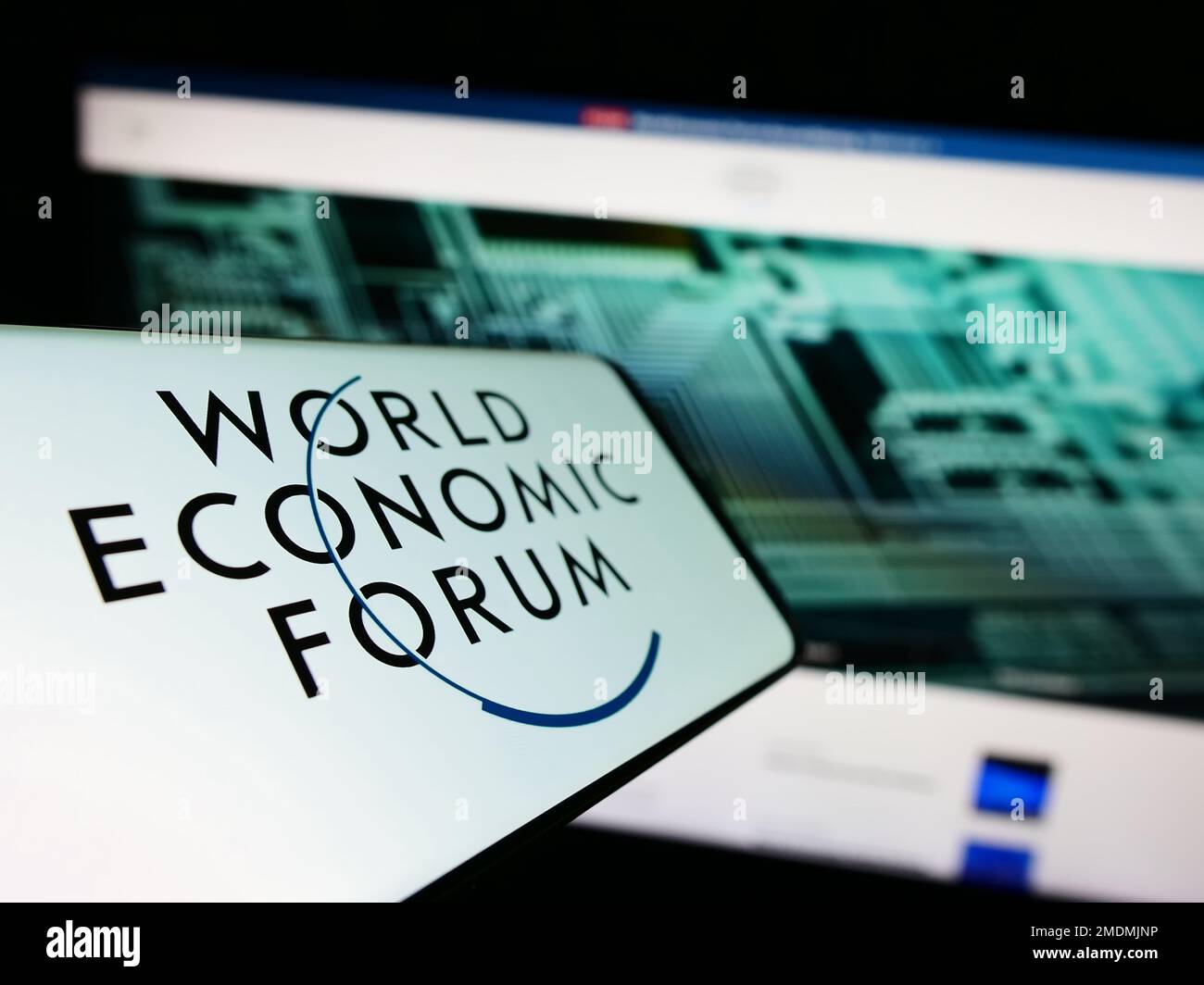 Smartphone with logo of organisation World Economic Forum (WEF) on screen in front of website. Focus on center-left of phone display. Stock Photo