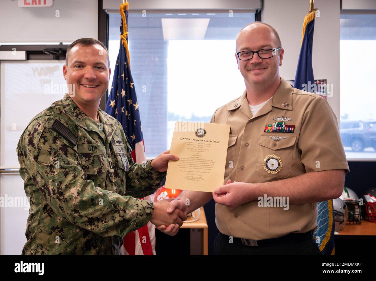 220726-N-WF272-1049 YORK, Pa. (July 26, 2022) U.S. Navy Lt. Joshua Udy, a native of Colorado Springs, Colo., enlisted programs officer assigned to Navy Talent Acquisition Group Philadelphia, presents a reenlistment certificate to Firecontrolman (Aegis) 1st Class Christopher Odierno, a native of San Diego, during a reenlistment ceremony held at Navy Recruiting Station York, July 26, 2022. NTAG Philadelphia encompasses regions of Pennsylvania, New Jersey, Delaware, Maryland and West Virginia, providing recruiting services from more than 30 talent acquisition sites with the overall goal of attrac Stock Photo