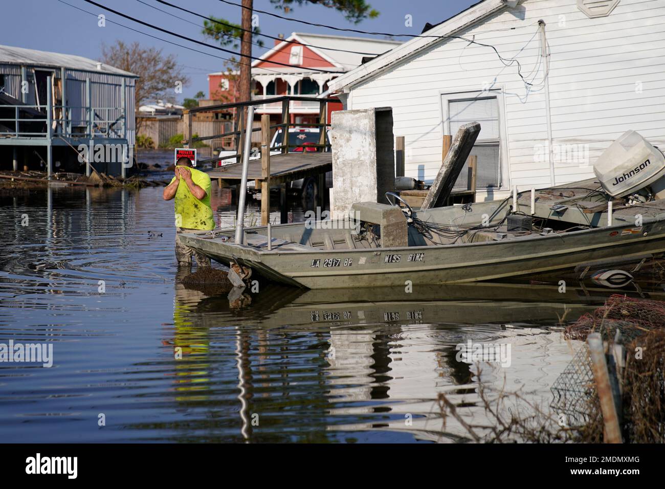 Nathan Fabre wipes sweat from his face while checking on his home and boat  in the aftermath of Hurricane Ida, Sunday, Sept. 5, 2021, in Lafitte, La.  "We lost everything," said Fabre