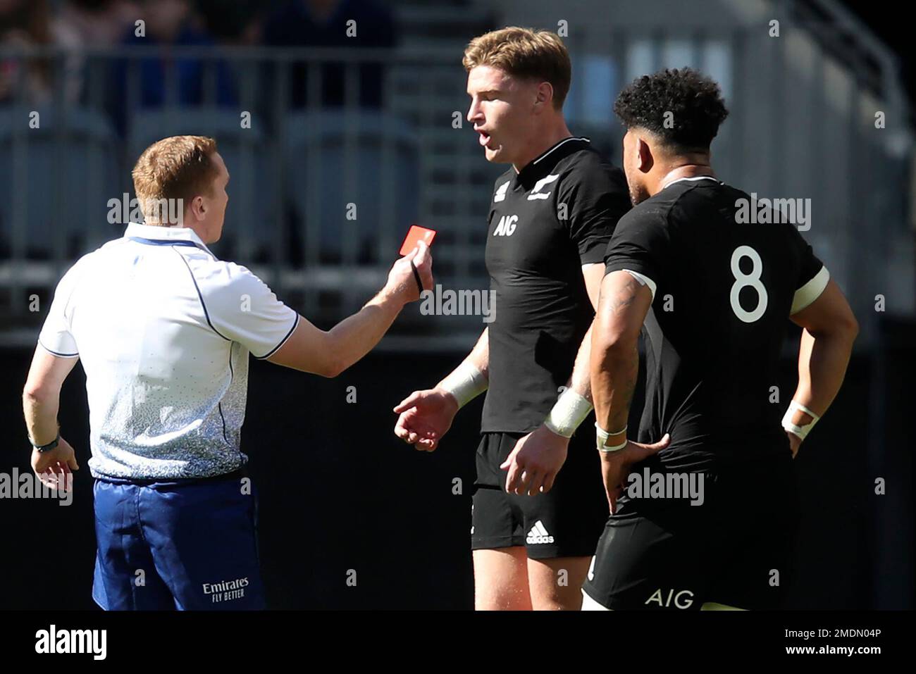 Referee Damon Murphy shows a red card to New Zealand's Jordie Barrett,  centre, as his captain Ardie Savea watches during the Rugby Championship  game between the All Blacks and the Wallabies in