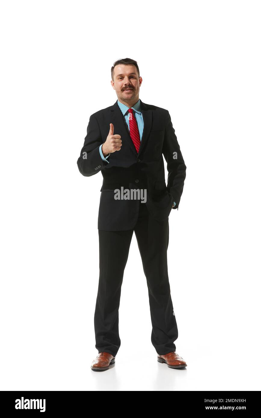 Businessman in a suit showing gesture of approvement and positivity over white studio background. Concept of business, career, innovations, ad Stock Photo
