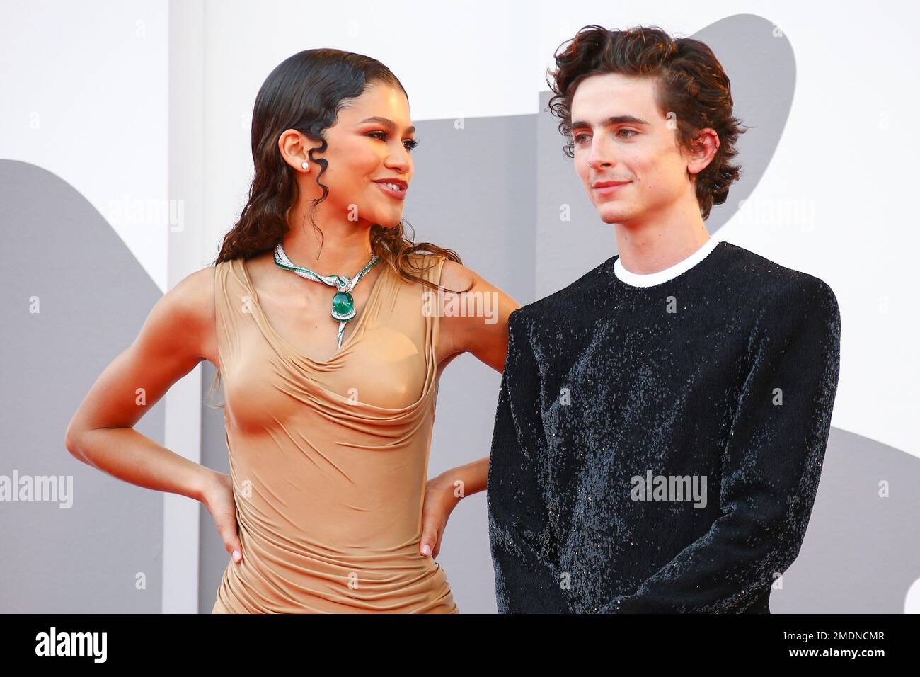 Zendaya, left, and Timothee Chalamet pose for photographers upon