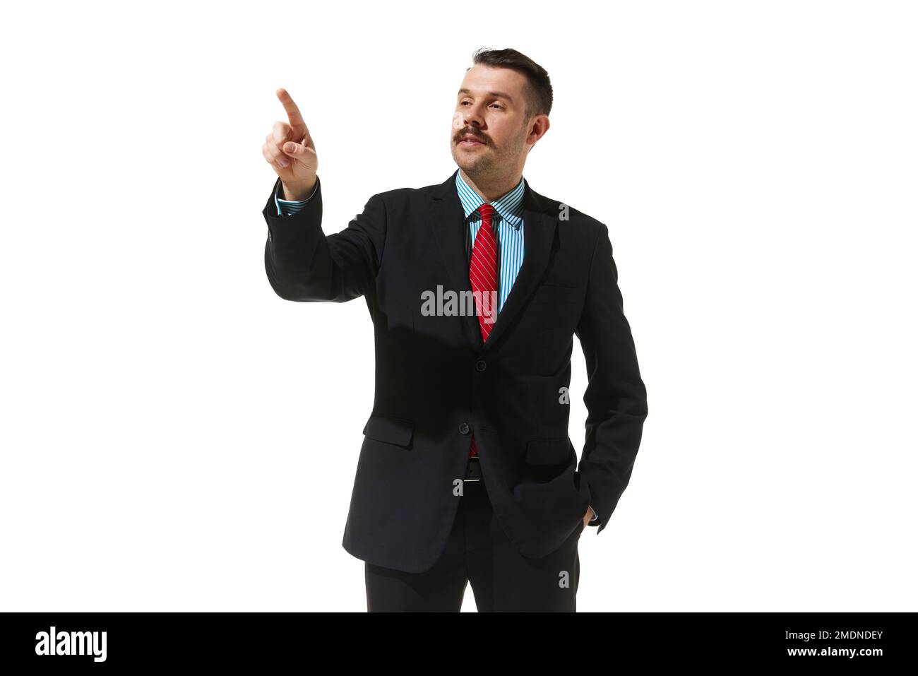 Businessman in a suit pointing with finger over white studio background. Checking project. Concept of business, career, innovations, ad Stock Photo