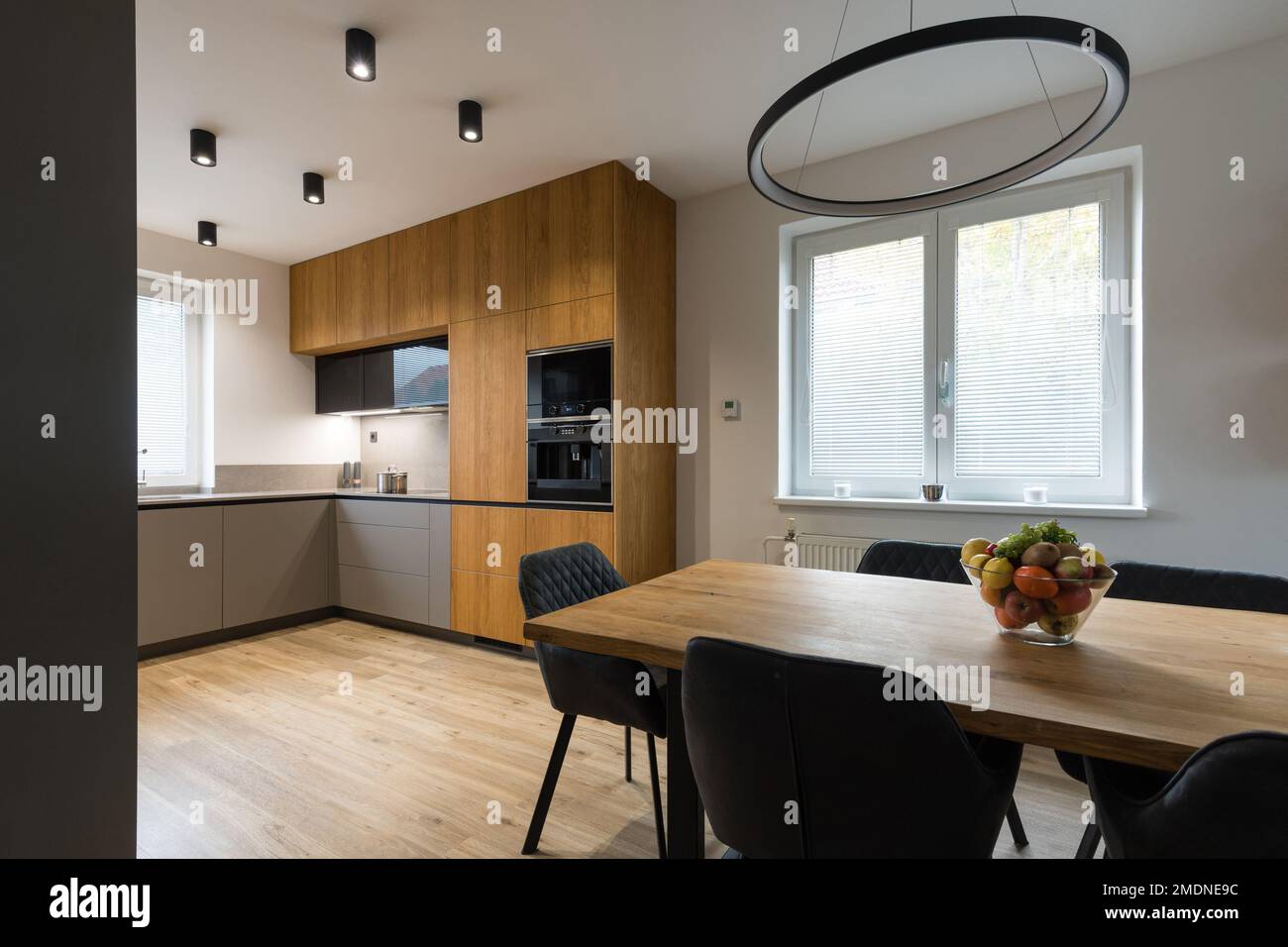 Modern kitchen with built in appliances and dining table Stock Photo ...