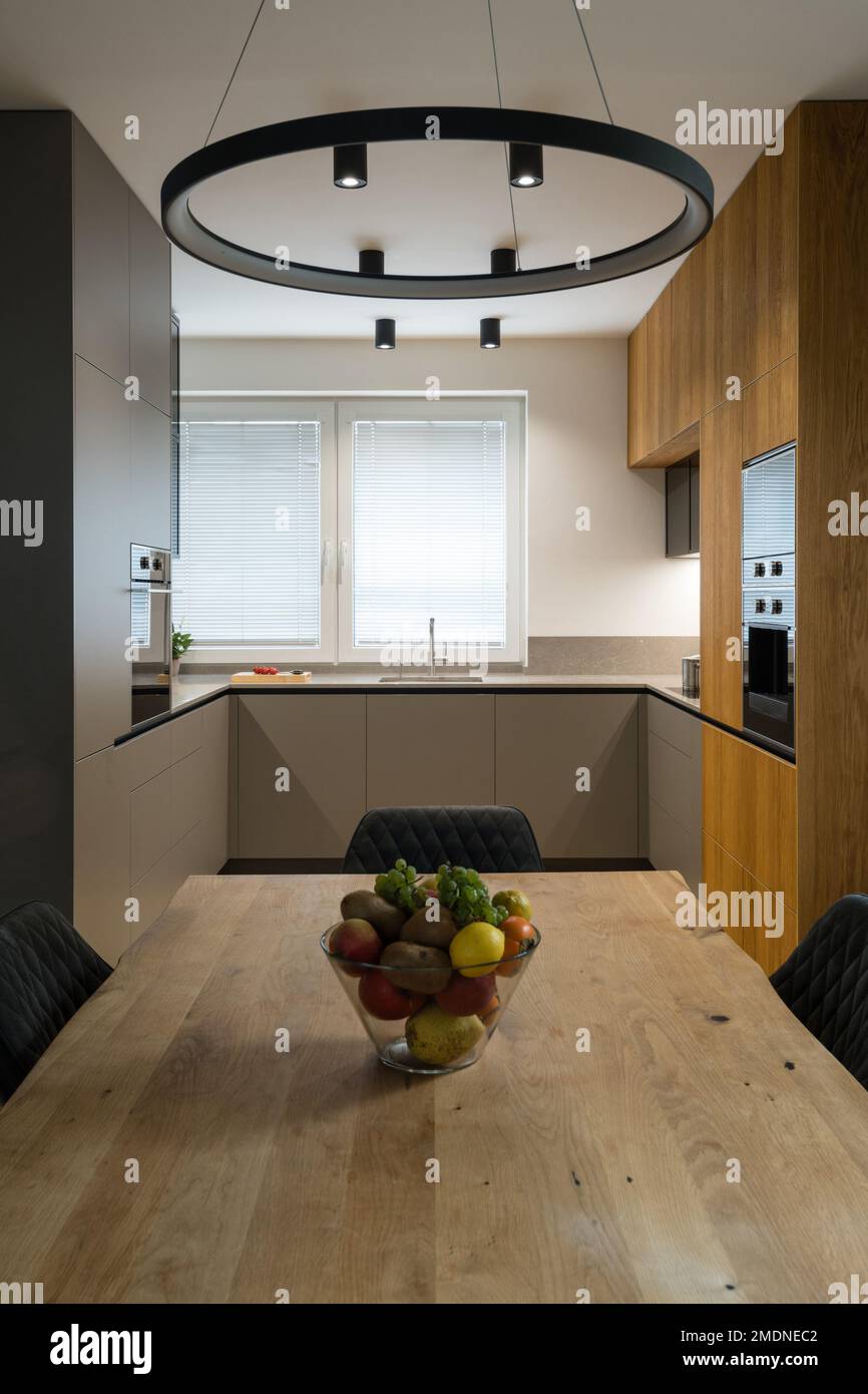 Modern kitchen with built in appliances and dining table Stock Photo ...