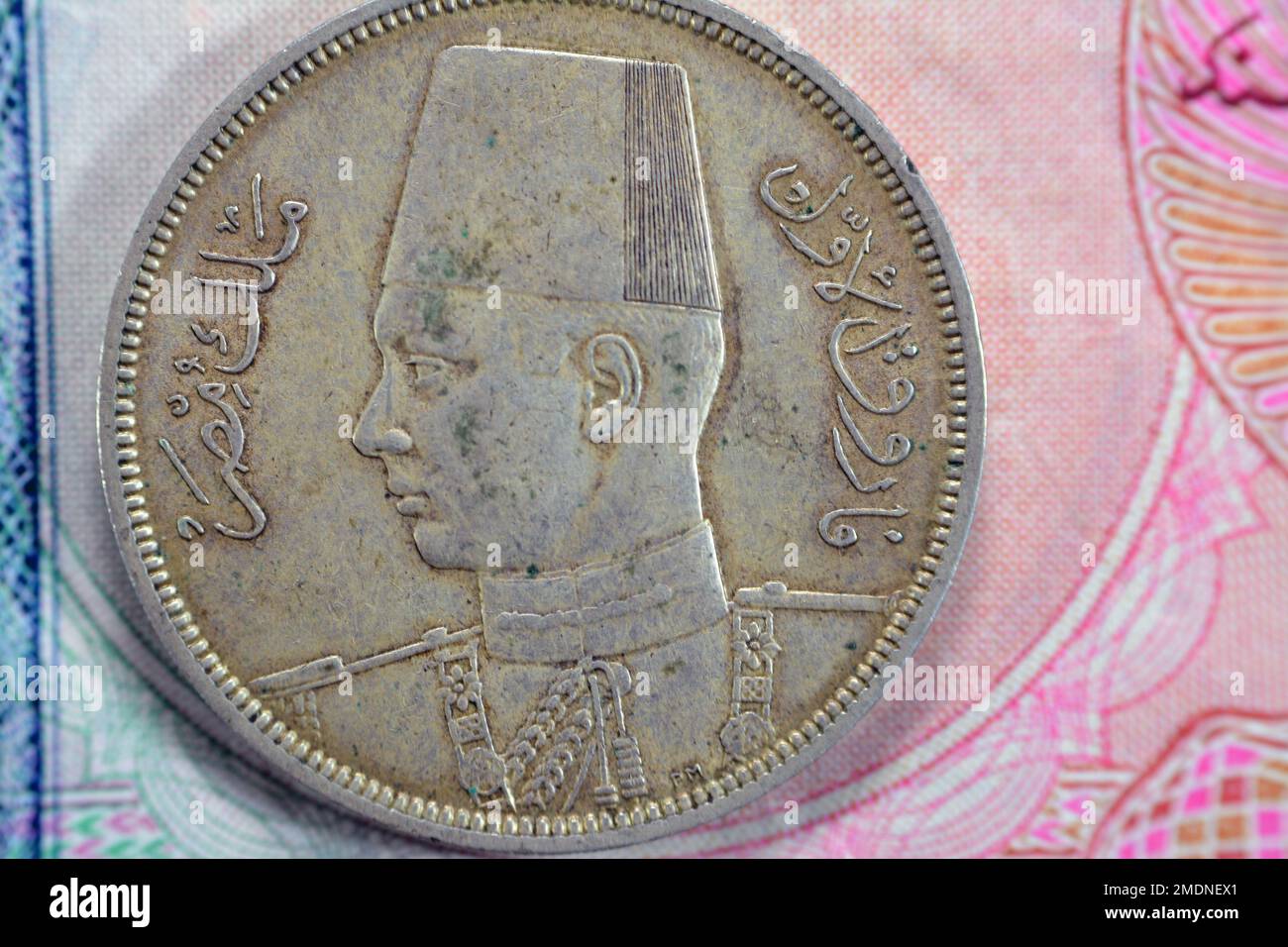 Ancient old ten 10 Egyptian piasters coin at the era of king Farouk I features value and kingdom of Egypt on a side and a bust of King Farouk the 1st Stock Photo