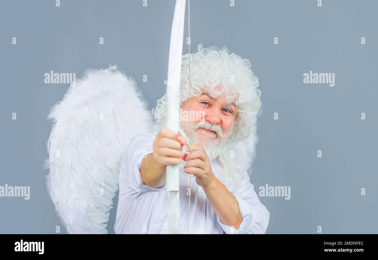 Valentines Day. Valentine cupid shooting arrow with bow. Bearded angel throws arrows of love. Stock Photo