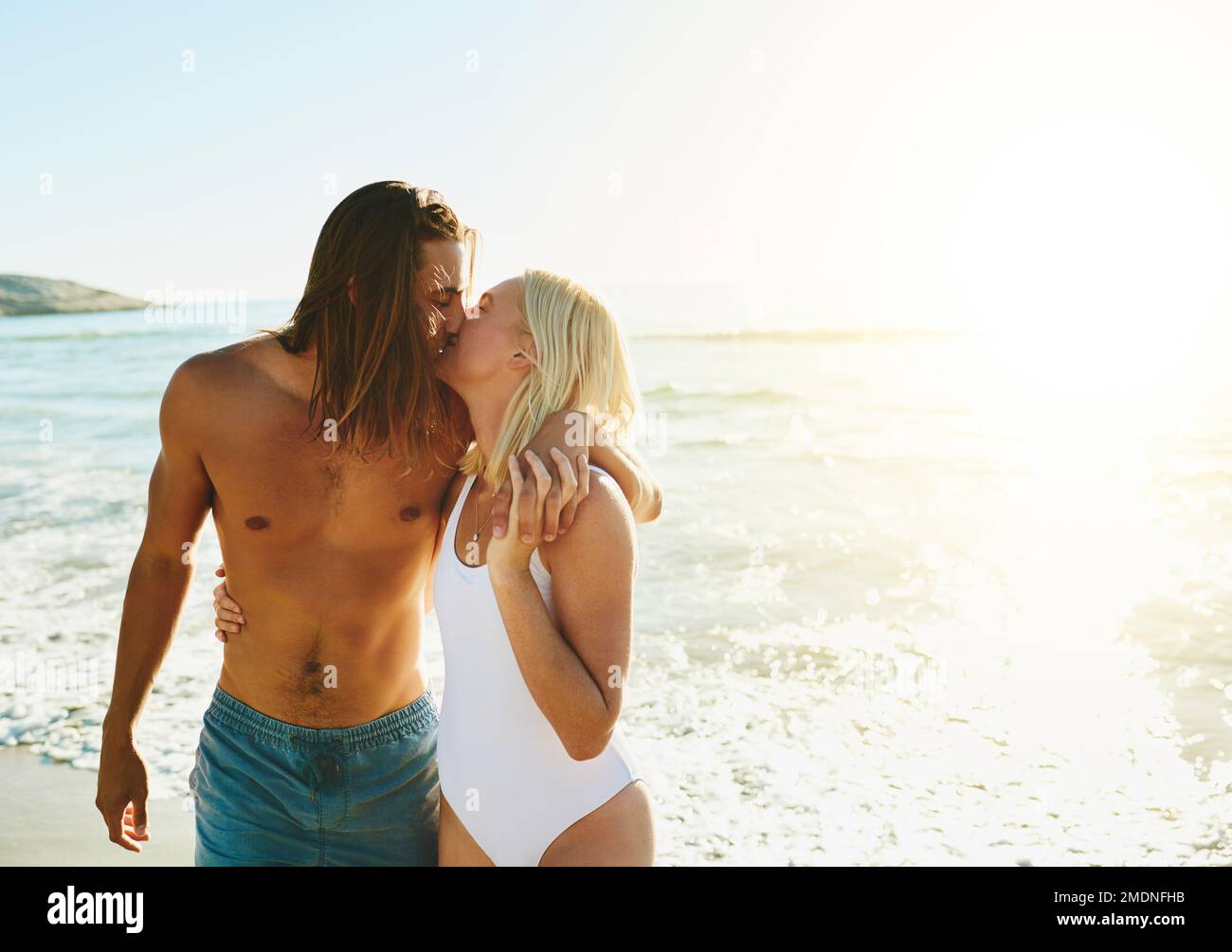 You are all that I need in my life. an affectionate young couple kissing each other at the beach. Stock Photo