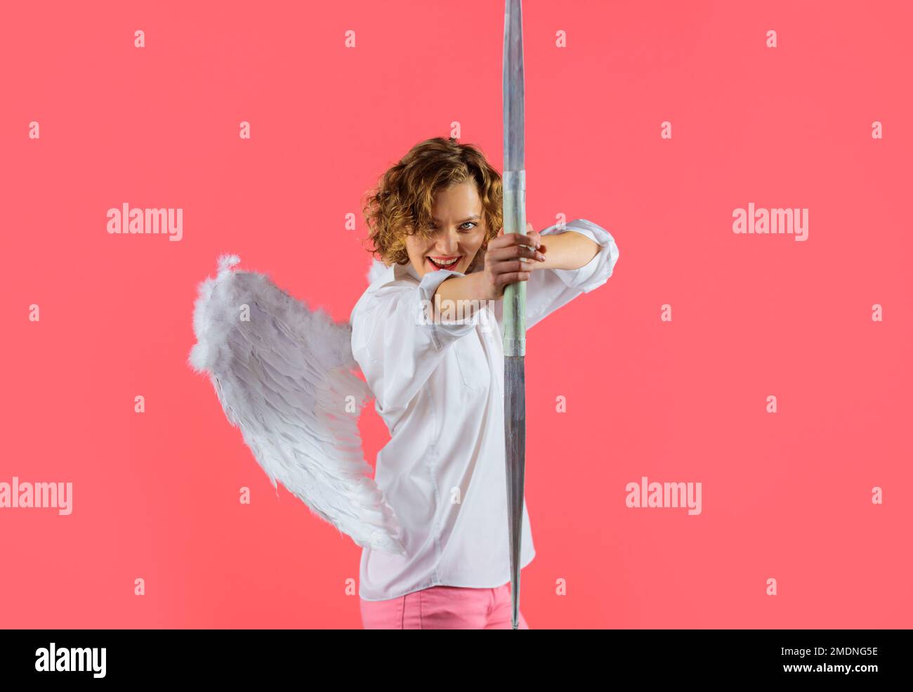 Cupid in valentines day. Female angel in white wings shooting with bow and arrow. Arrows of love. Stock Photo