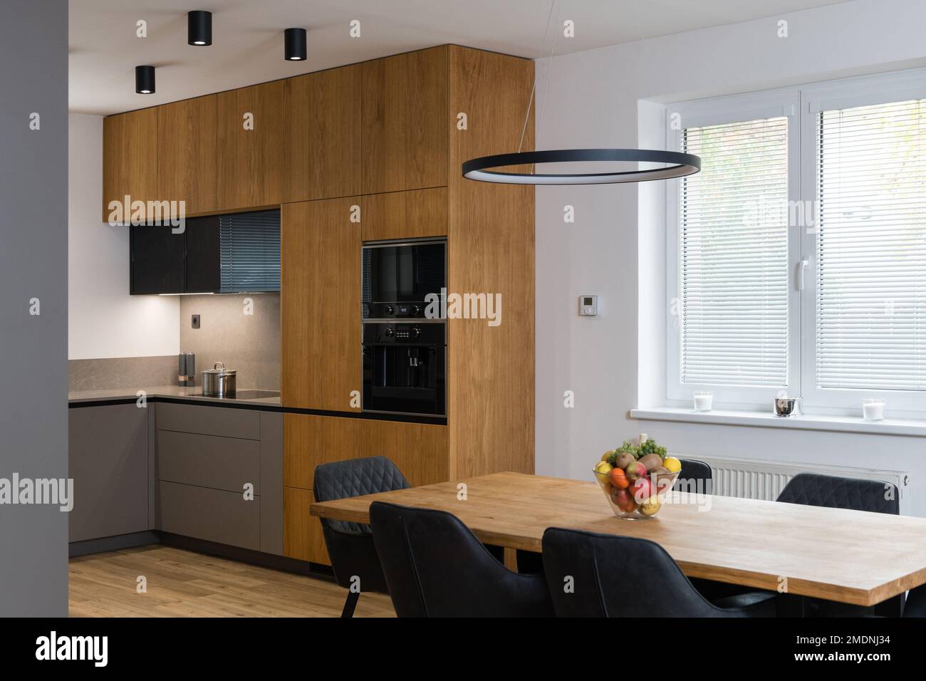 Modern kitchen with built in appliances and dining table Stock Photo ...
