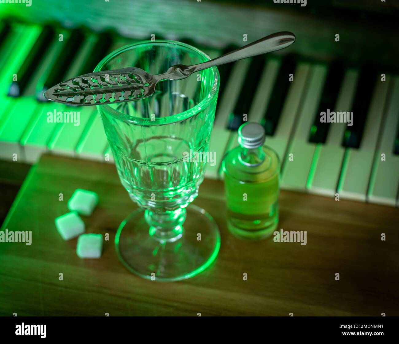 Drinking absinthe using traditional method with slotted spoon