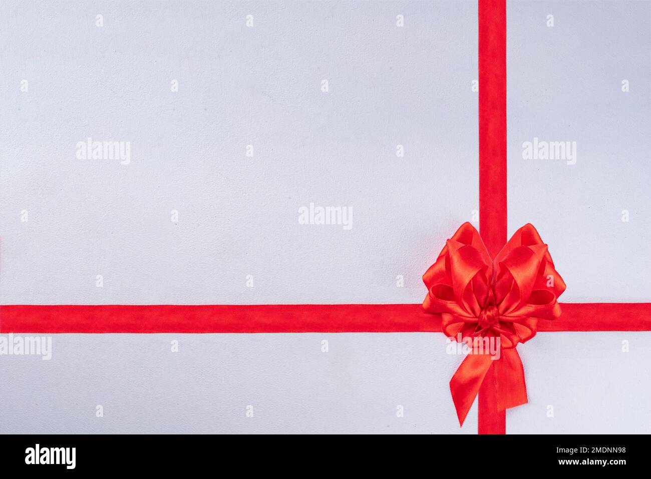 Heart shaped festive red bow and ribbon isolated on white background ...