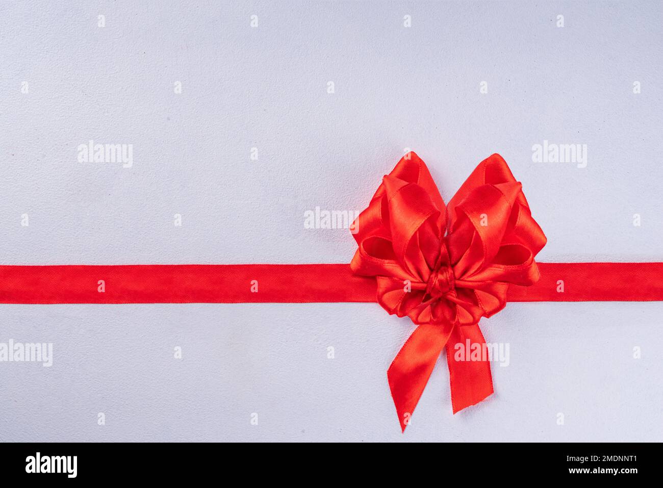 Heart shaped festive red bow and ribbon isolated on white background ...