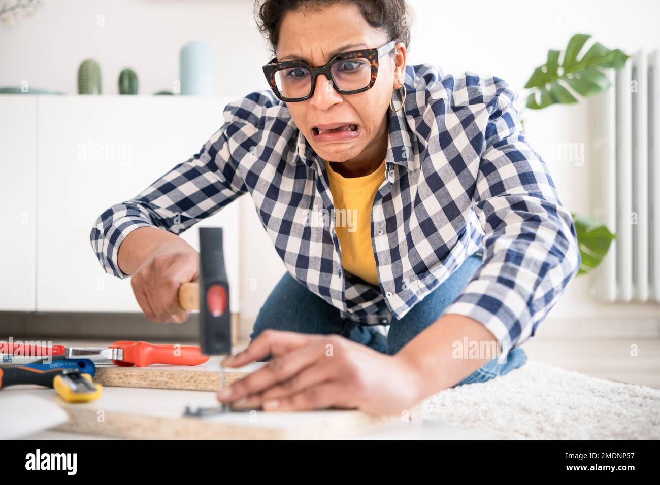Injured black woman during home renovation work, focus on face Stock Photo