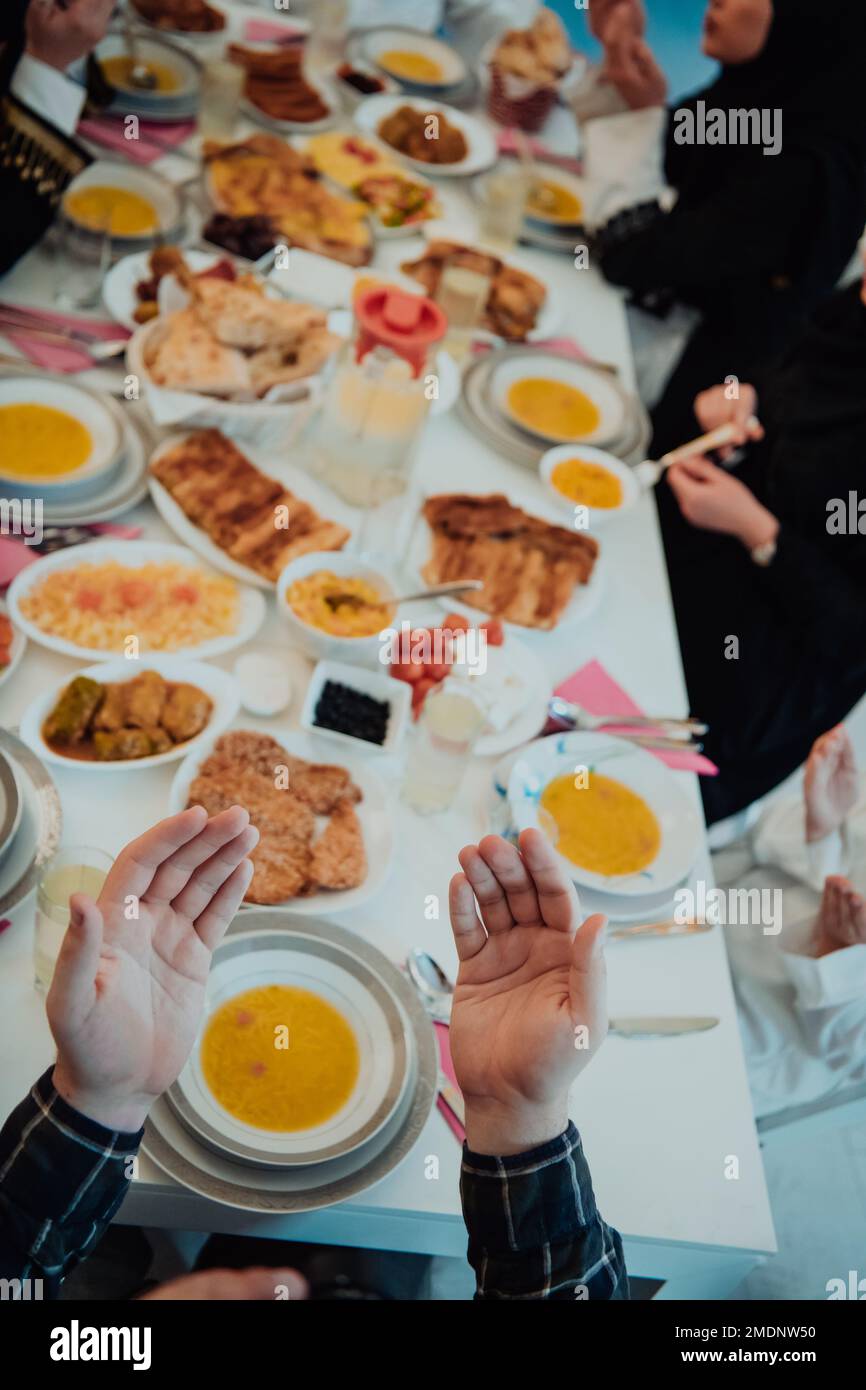 Top view of Muslim family having Iftar dinner drinking water to break