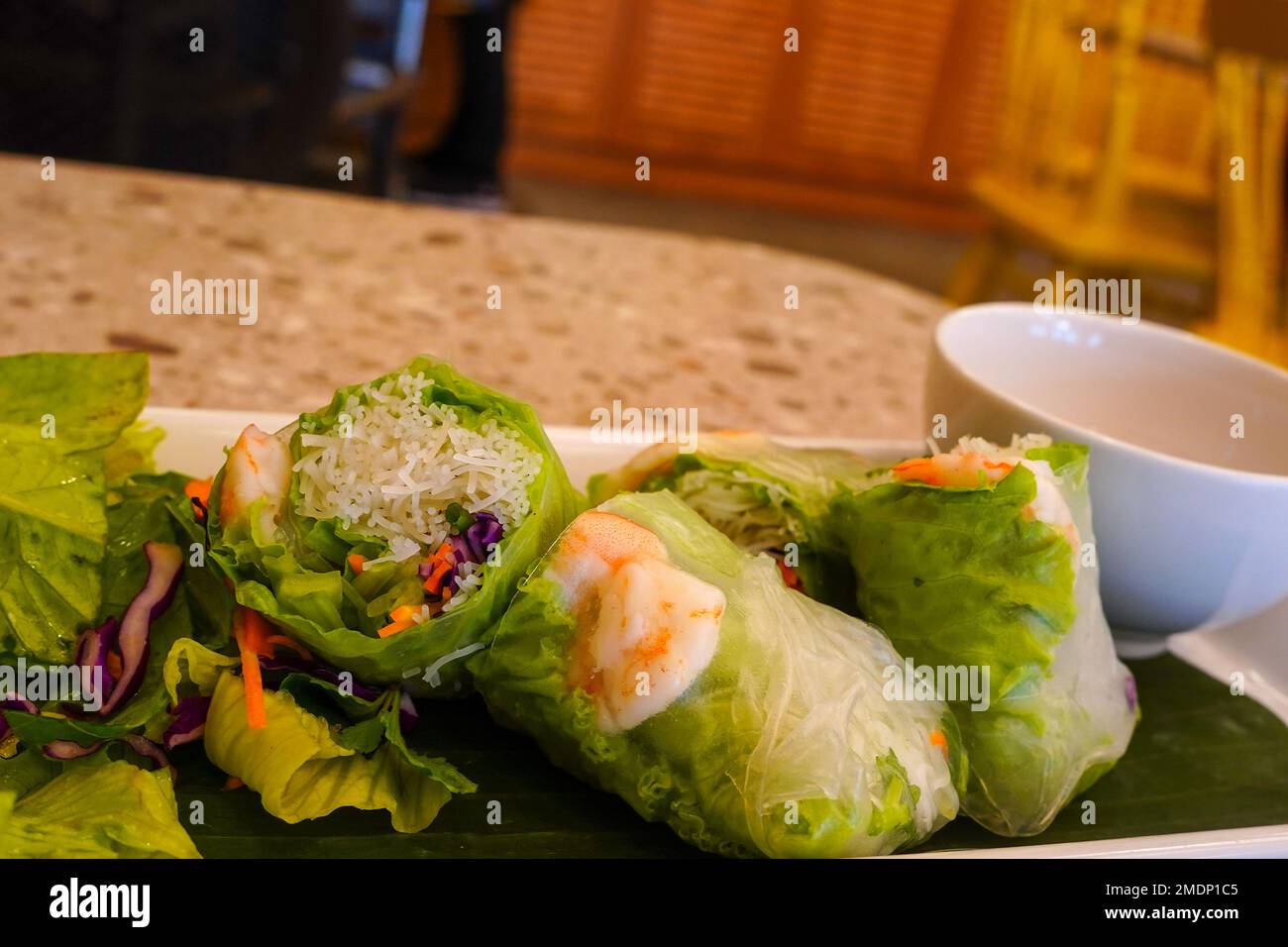 Fresh vietnamese spring rolls with peanut butter sauce for dipping