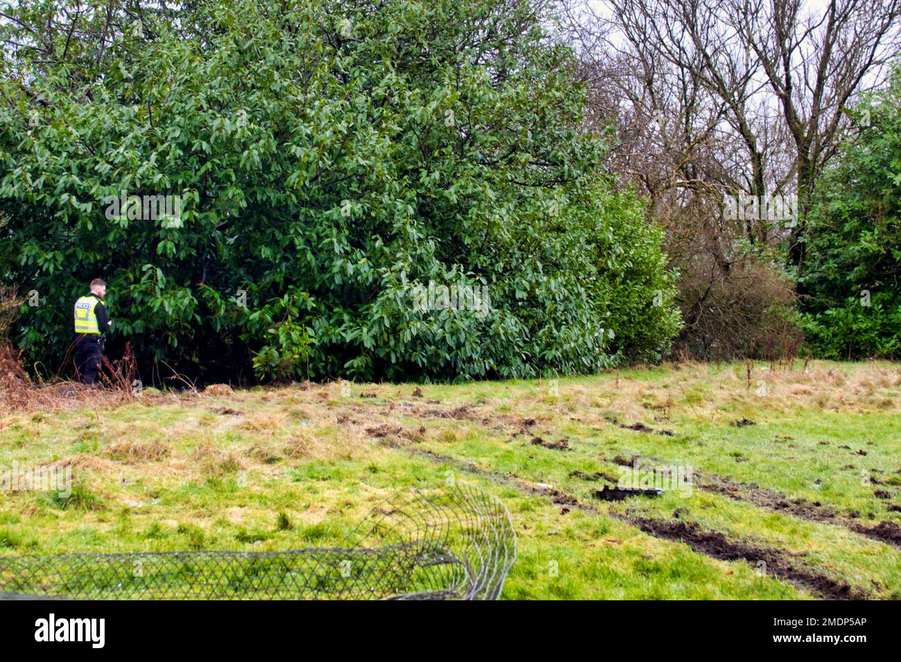Glasgow, Scotland, UK 23rdJanuary, 2023. Van crashes through sports field wire and into the side of the forth and clyde canal at Blairdardie on great western road. The torn up wire wall and concrete posts were intersected by train tracks in the soft football pitch credit  Gerard Ferry/Alamy Live News Stock Photo