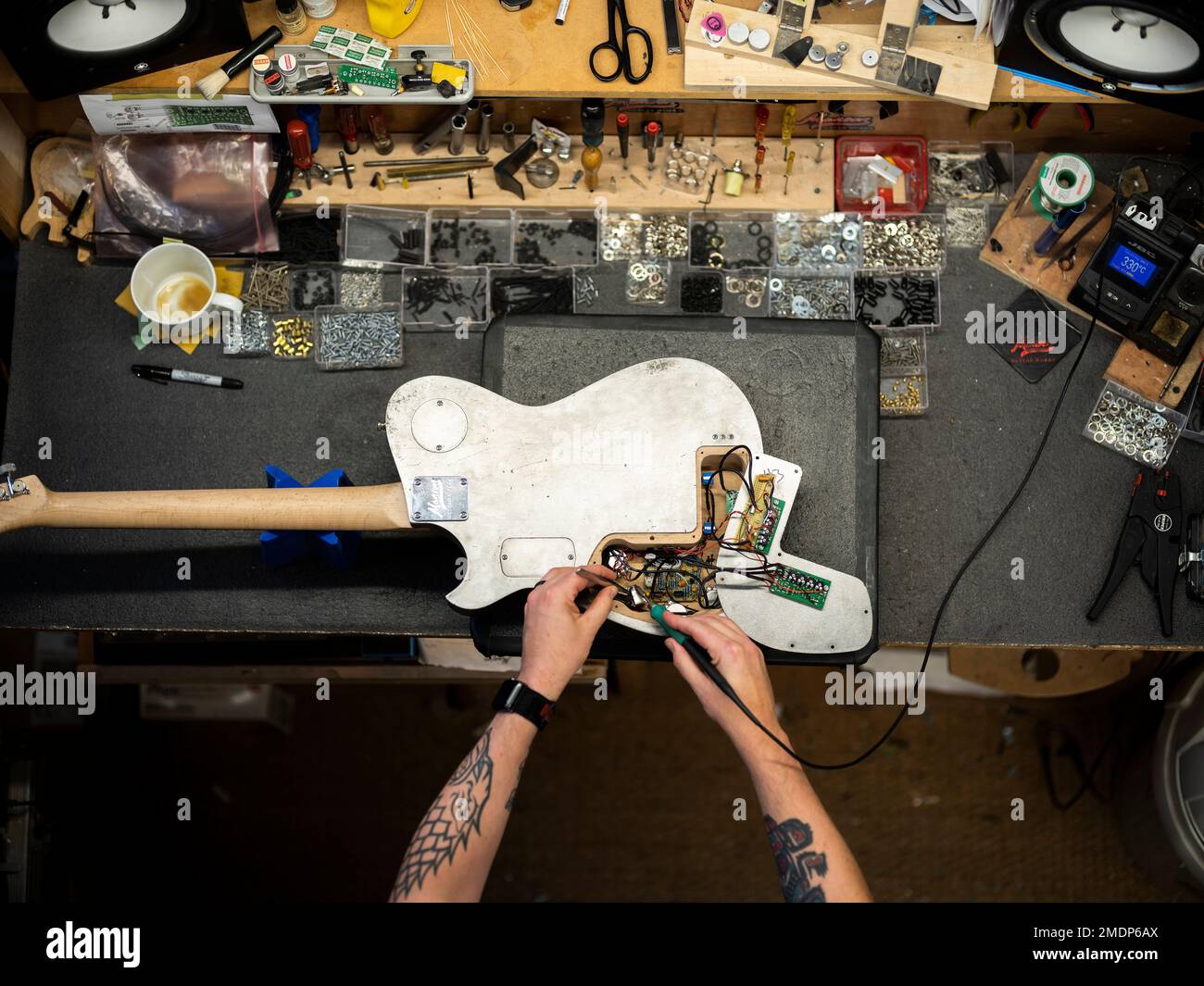Manson Guitar Works Matt Bellamy DL0R electric guitar on a work bench