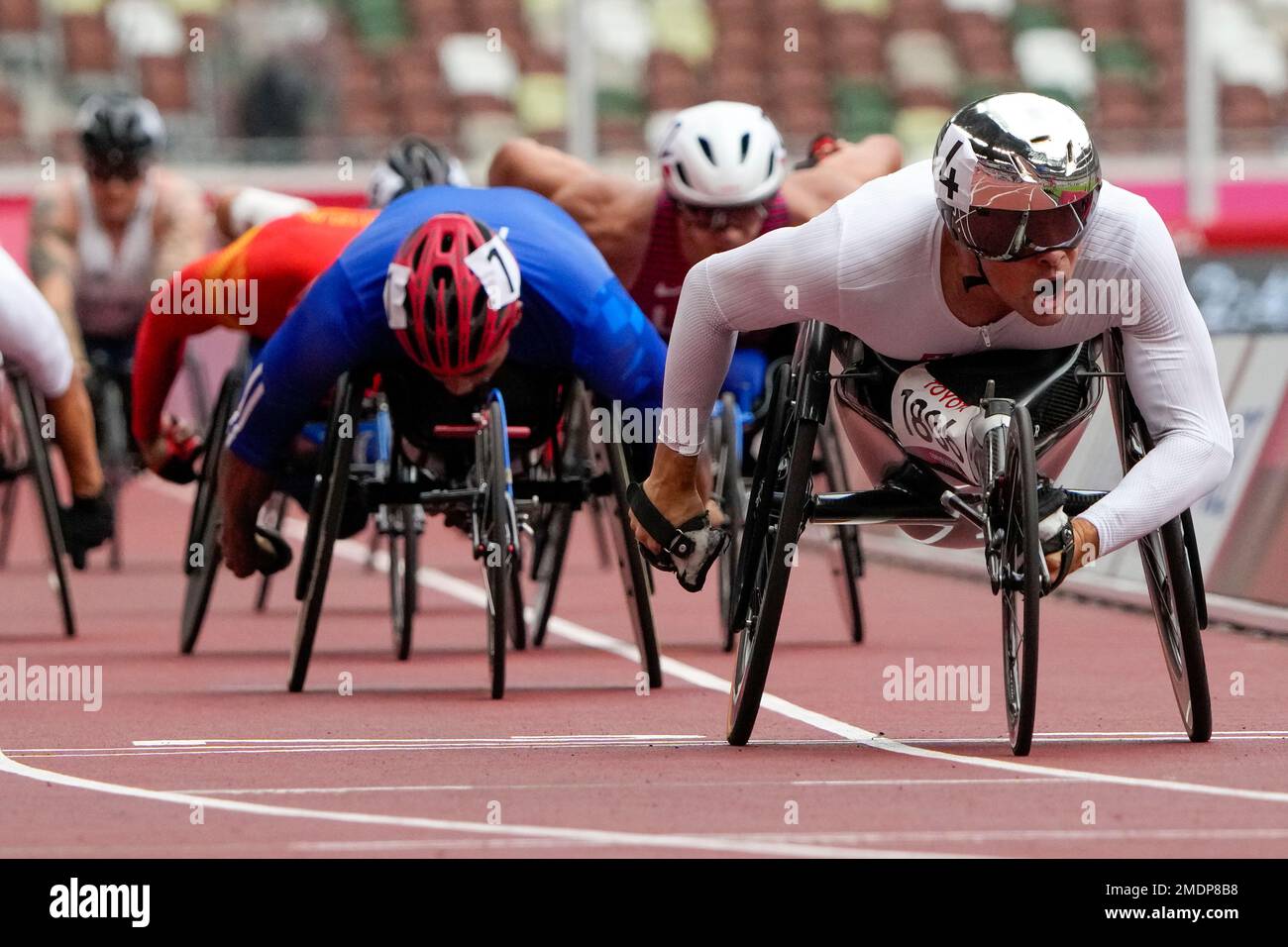 Switzerland's Marcel Hug celebrates as he crosses the finish line to