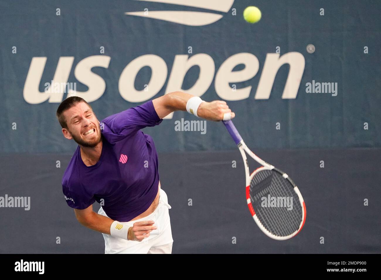 Cameron Norrie, of Britain, serves to Carlos Alcaraz, of Spain, during the first round of the US Open tennis championships, Monday, Aug
