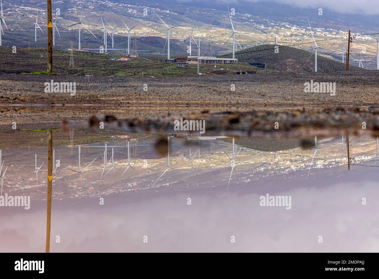 Windfarm turbines reflecting in a puddle at Abades, Granadilla de Abona, Tenerife, Canary Islands, Spain Stock Photo