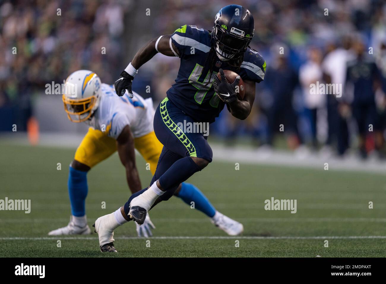 Seattle Seahawks running back Alex Collins carries the ball against the  Denver Broncos during the first half of an NFL football preseason game,  Saturday, Aug. 21, 2021, in Seattle. (AP Photo/John Froschauer