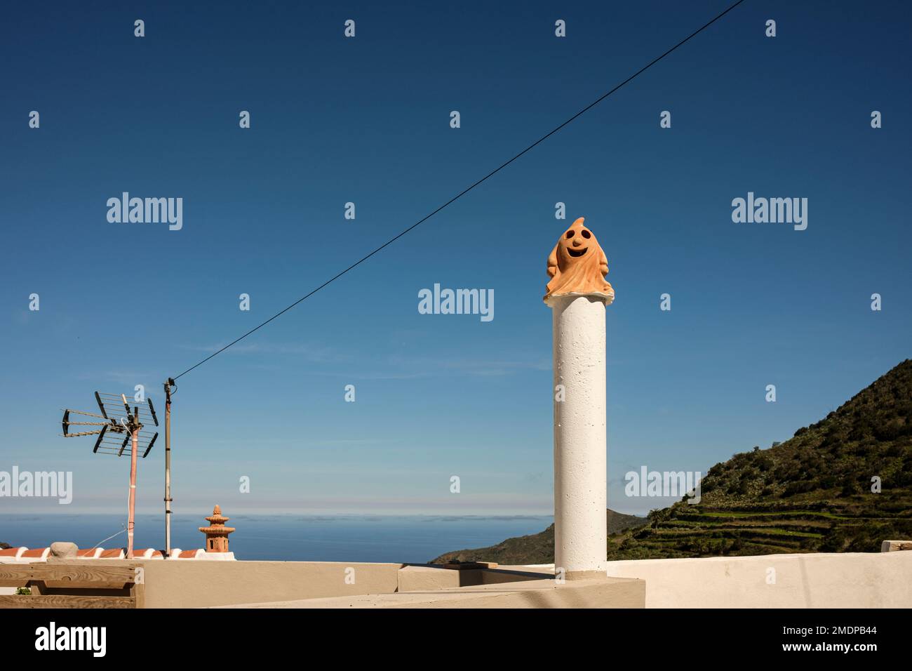 Terracotta chimney pot top in the form of a comical ghost character in Palmar, Tenerife, Canary Islands, Spain Stock Photo