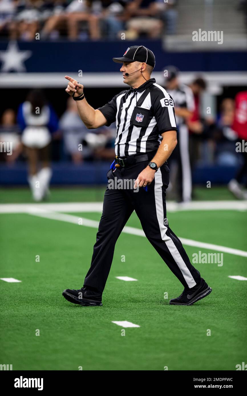 NFL back judge Brad Freeman stands on the field during an NFL