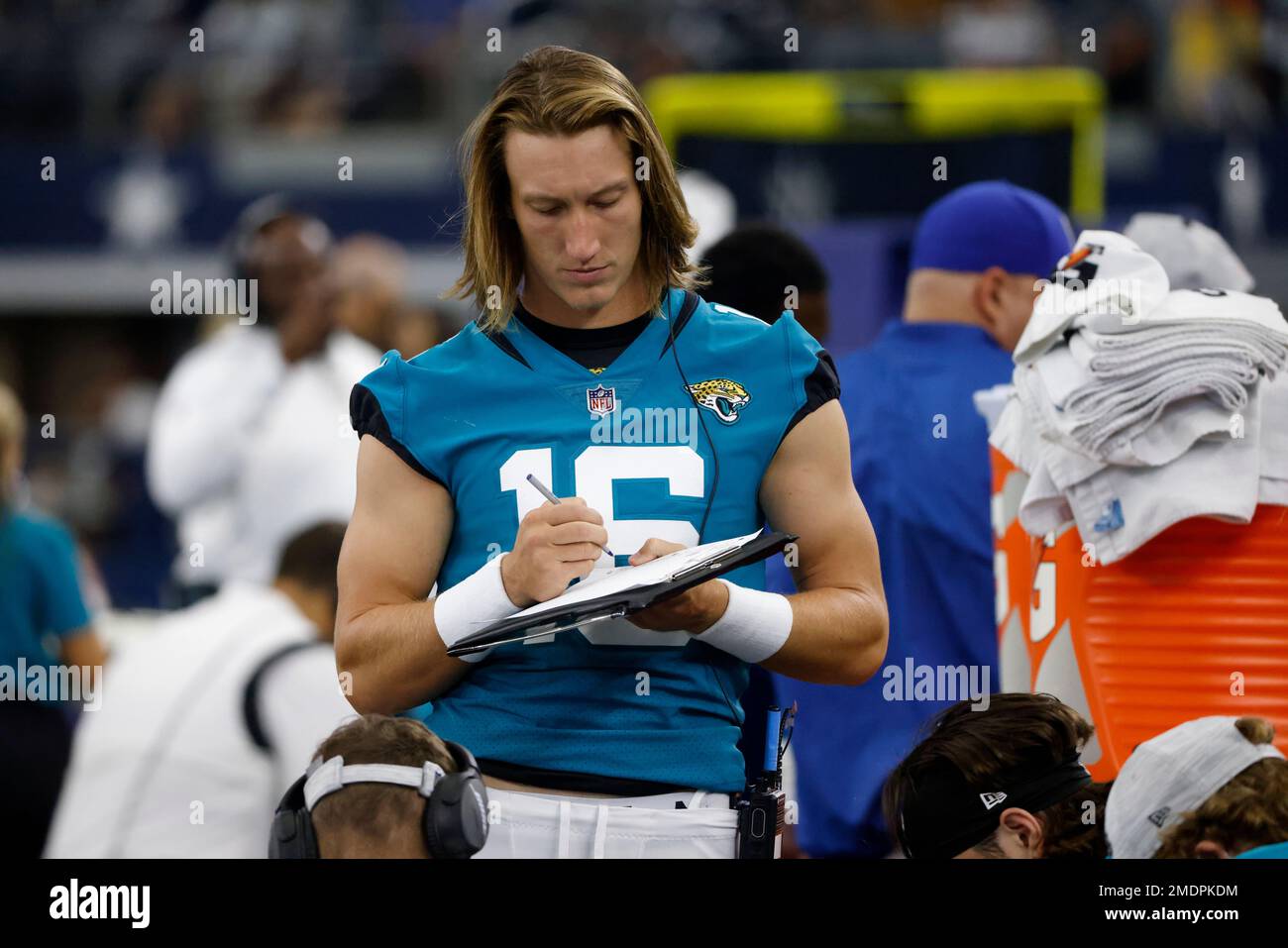 Jacksonville Jaguars quarterback Trevor Lawrence takes notes as he watches  play against the Dallas Cowboys in the second half of a preseason NFL  football game in Arlington, Texas, Sunday, Aug. 29, 2021. (