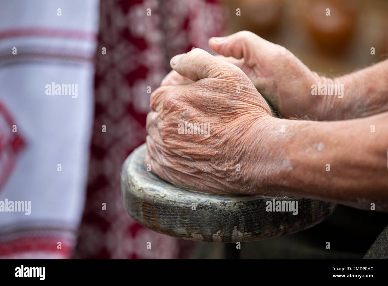 The old hands of the master make products from clay. Work on the potter ...
