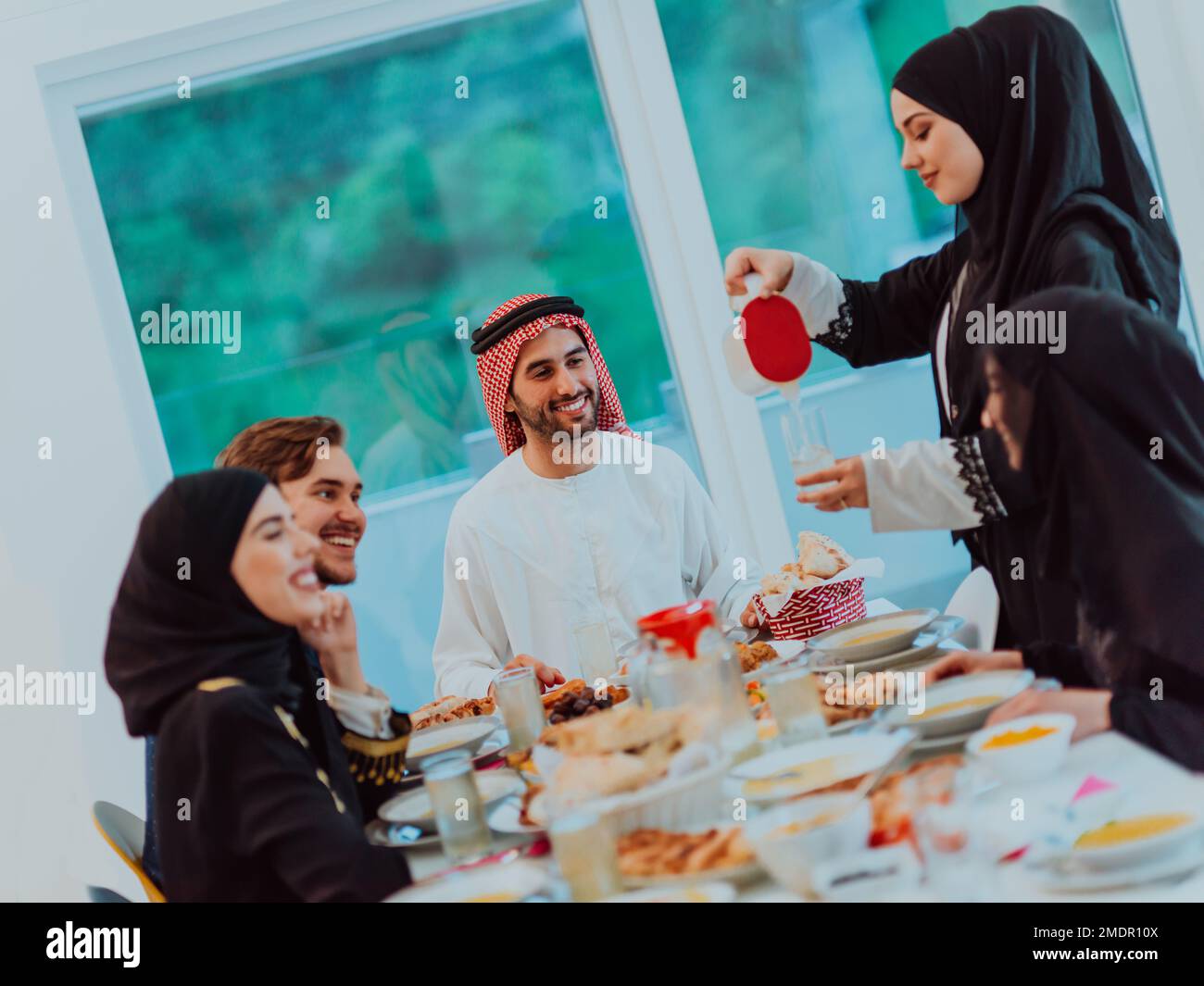 Eid Mubarak Muslim family having Iftar dinner drinking water to break