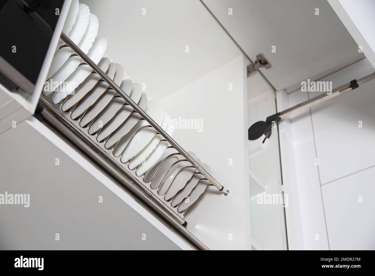 Storage of clean dishes in a separate kitchen section with a lifting