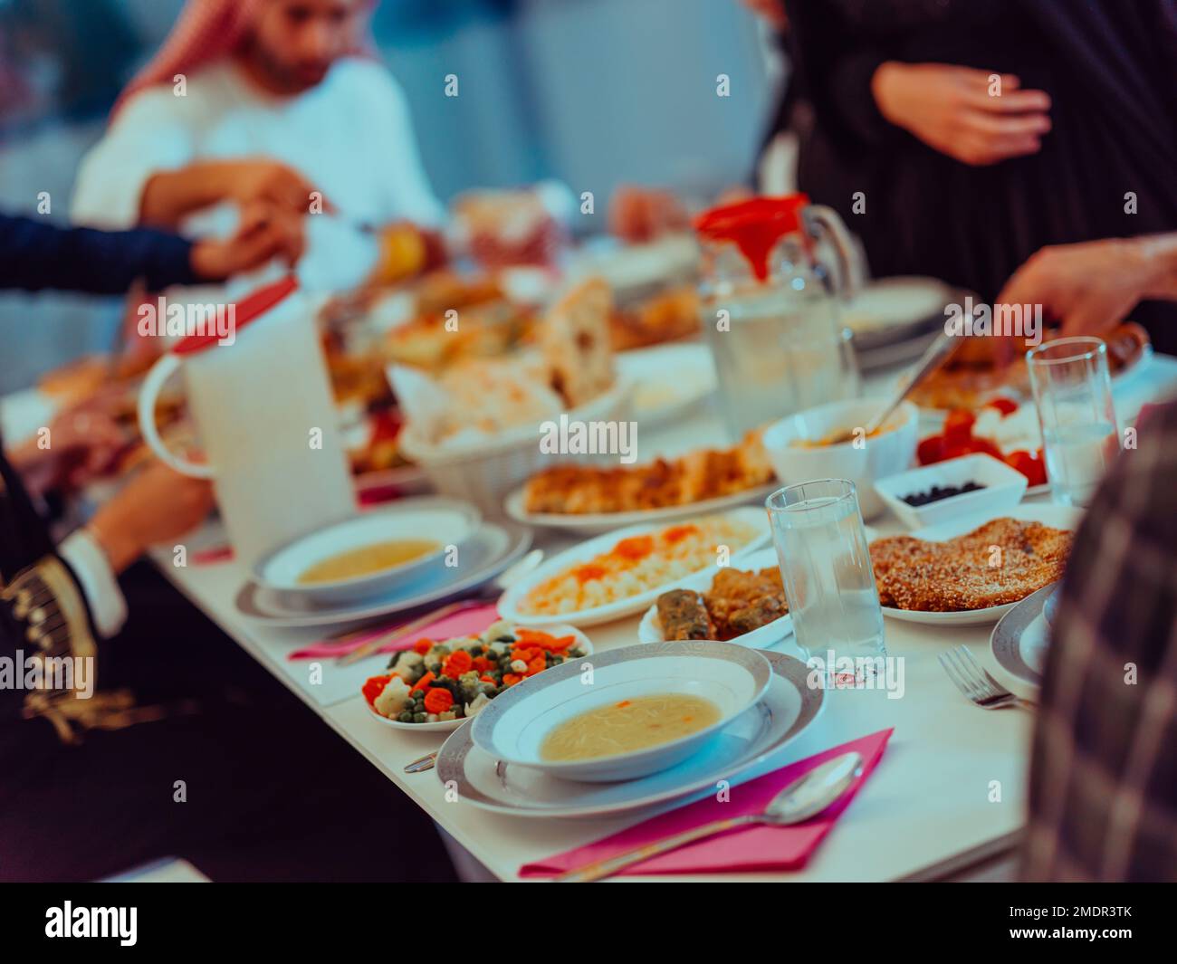 Eid Mubarak Muslim family having Iftar dinner drinking water to break