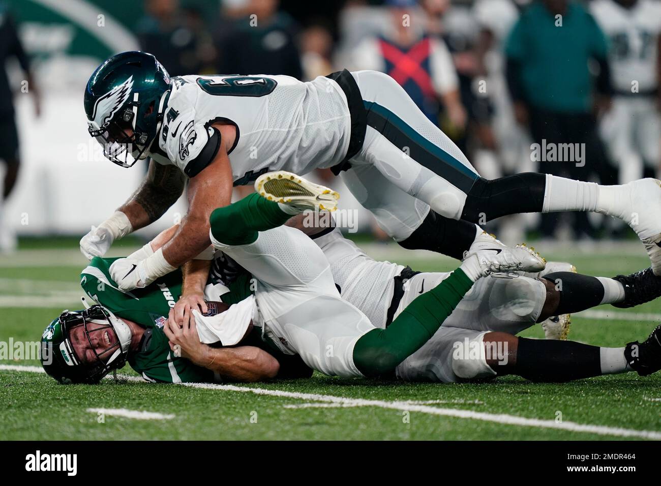 New York Jets quarterback James Morgan, below, is sacked by Philadelphia  Eagles' Matt Leo (64) and T.Y. McGill during the second half of an NFL  preseason football game Friday, Aug. 27, 2021,
