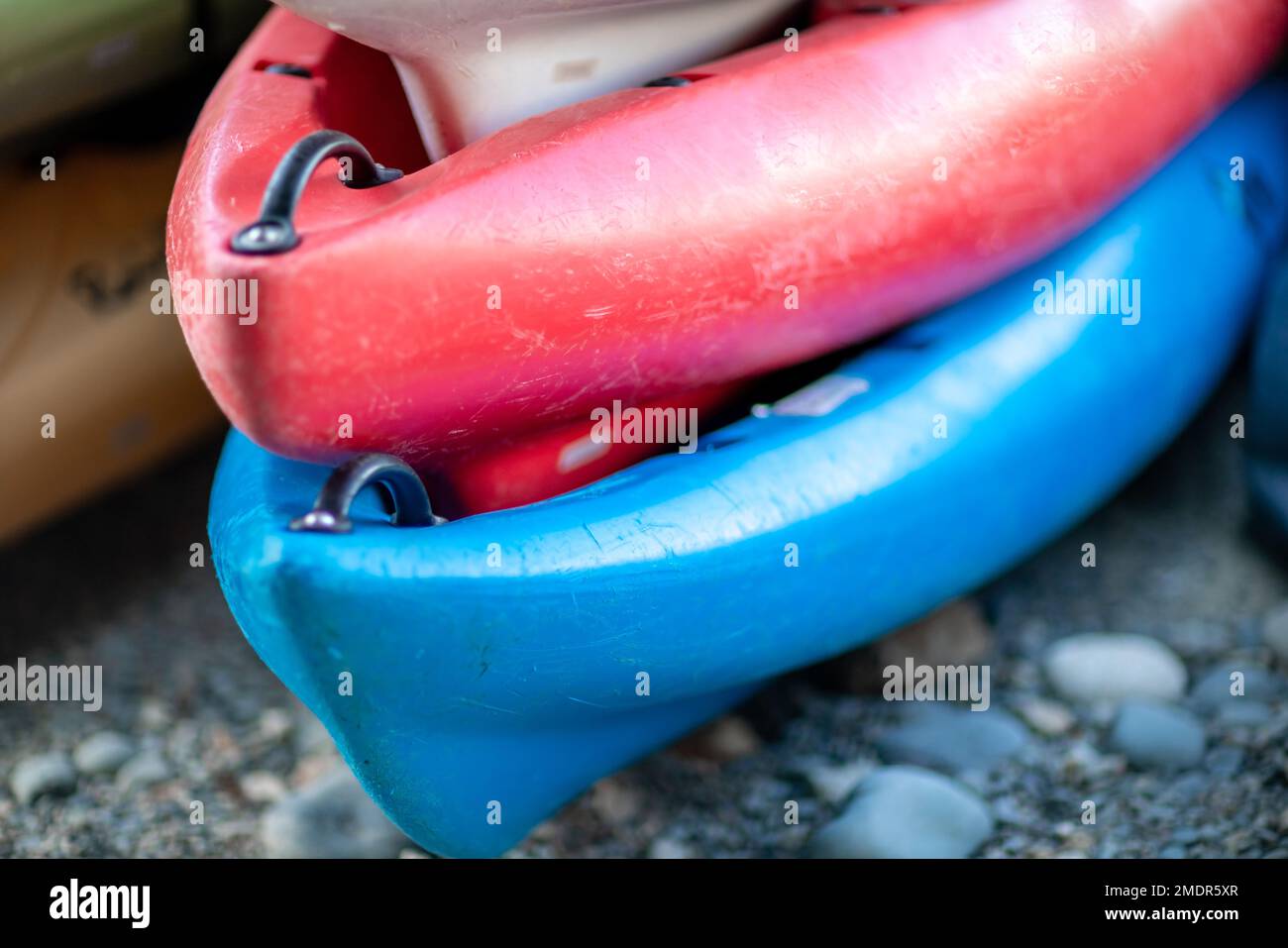 Close up shot of several Kayaks stowed by the sea shore Stock Photo