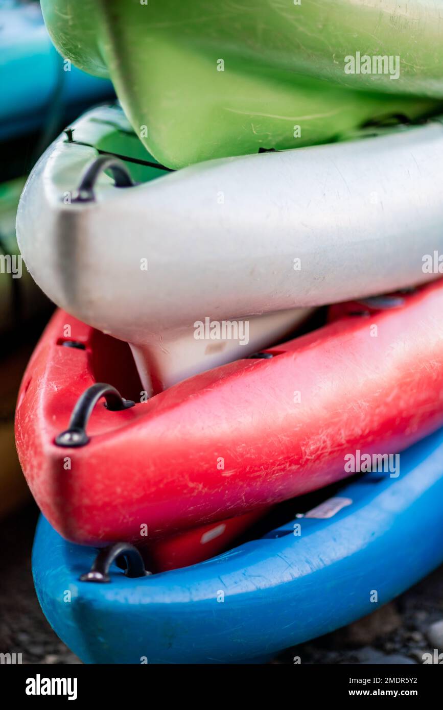 Close up shot of several Kayaks stowed by the sea shore Stock Photo