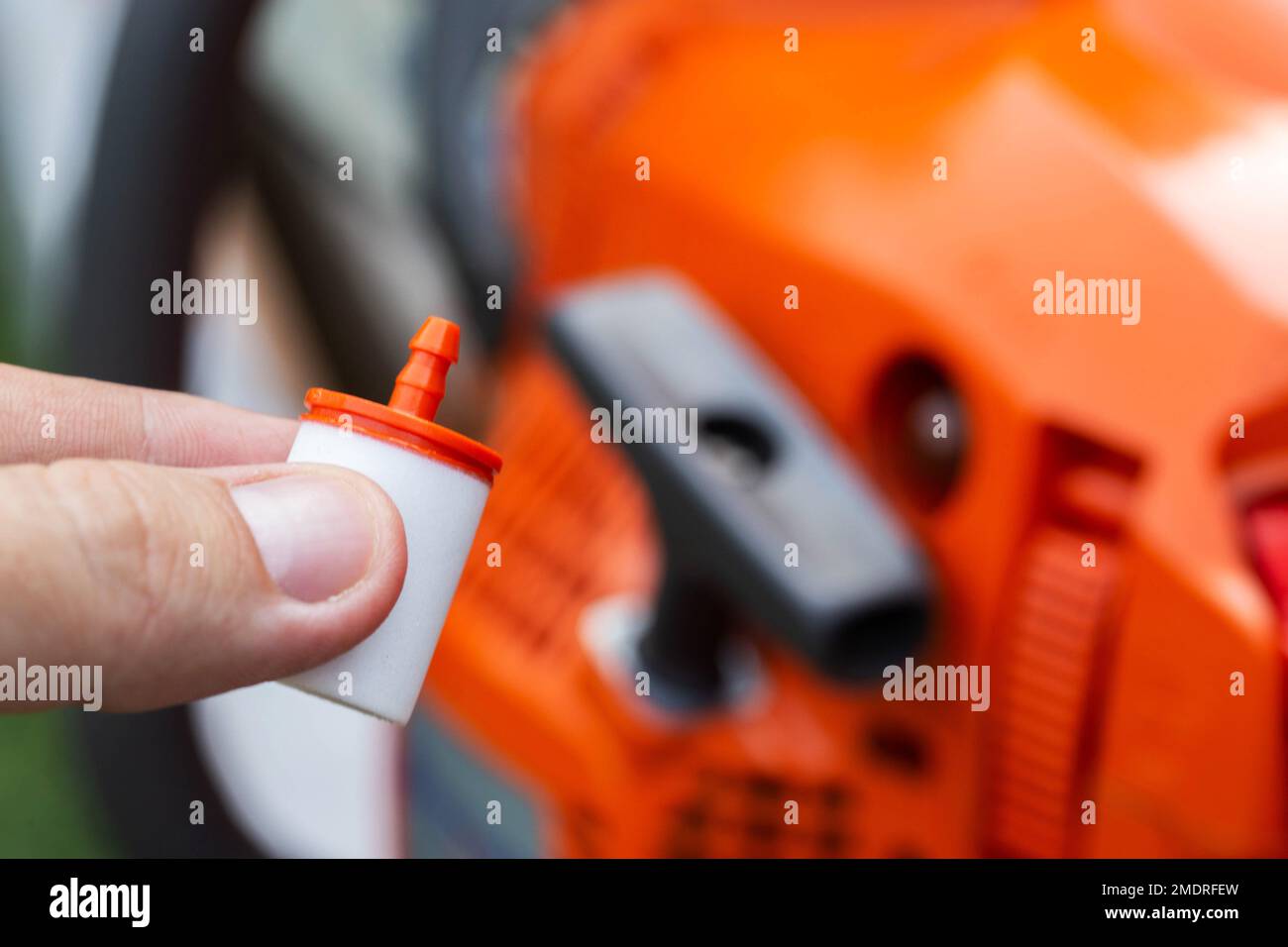 New fuel filter on the background of a chainsaw. The concept of