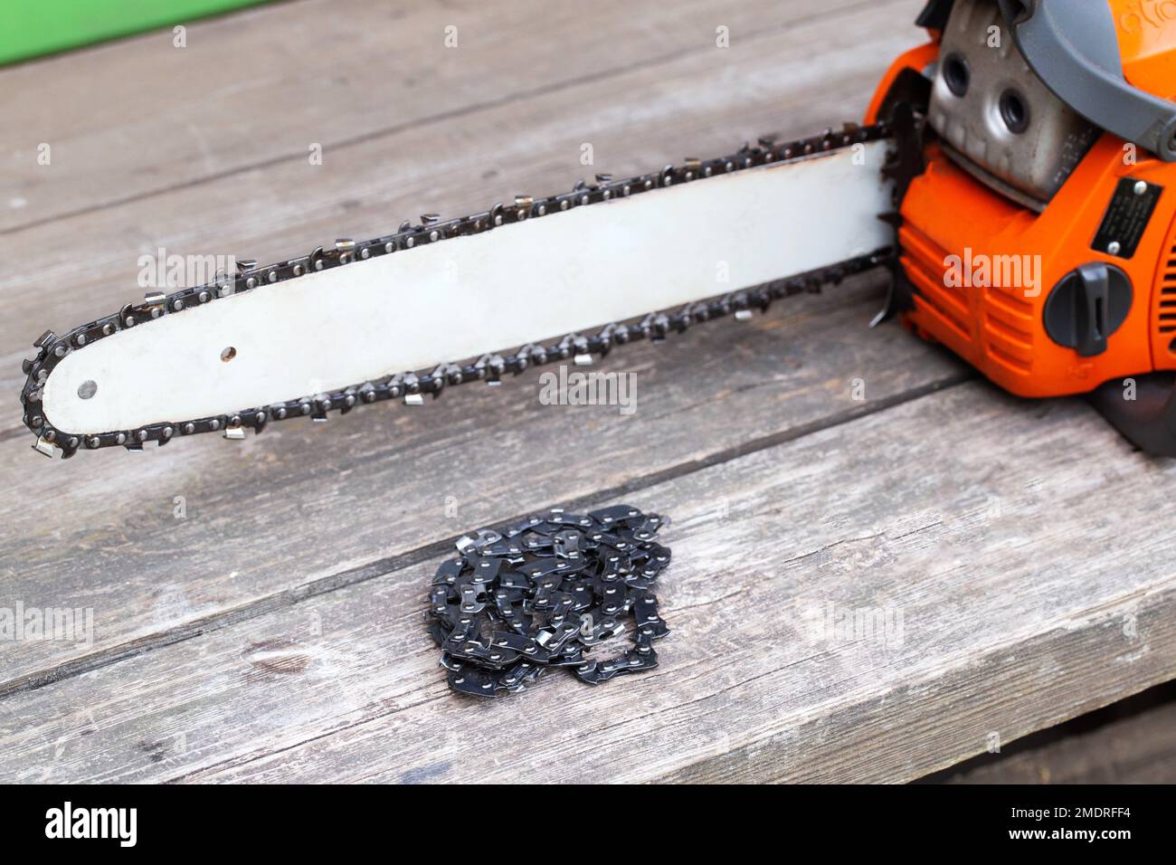 New chain for chainsaw. Setting up and replacing the chain on the chainsaw from the old to the new. Chain sharpening. Stock Photo
