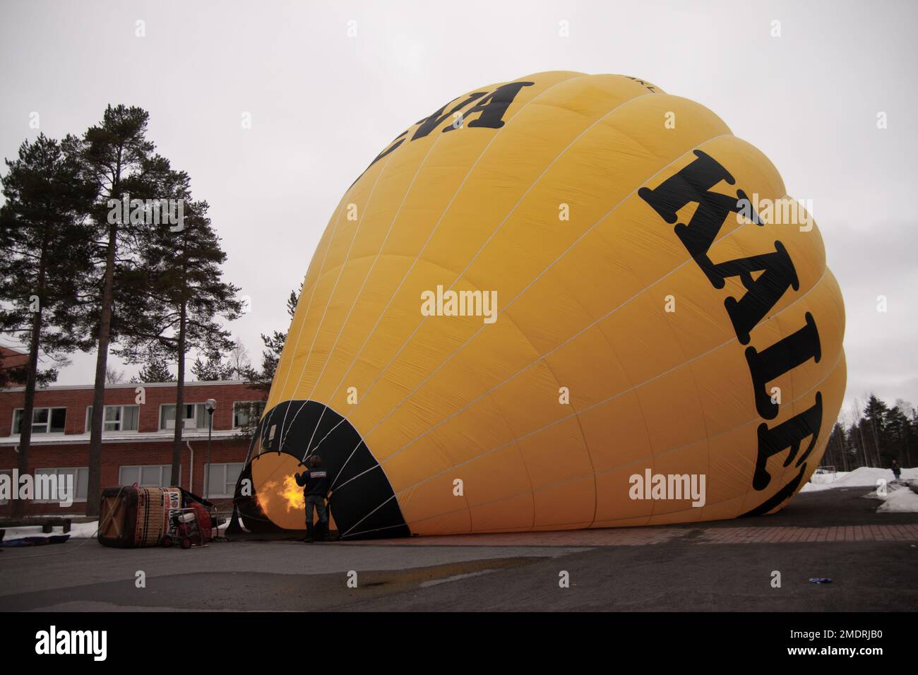 A hot air balloon flight in Finland. Photoshoot taken when the balloon was on the ground for fill up and during lift off and flight. Cold winter day Stock Photo