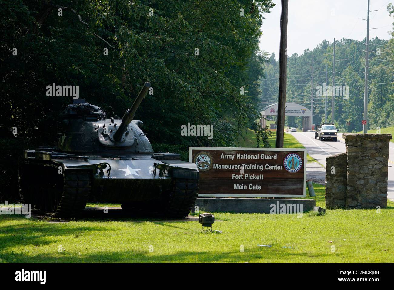 Traffic moves toward a tank and sign at the main entrance to Fort Pickett  Wednesday, Aug. 25, 2021, in Blackstone, Va. Afghan refugees who have been  prescreened by the . Department of