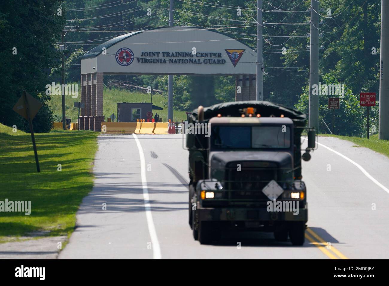 A military truck exits the main gate to Fort Pickett Wednesday, Aug. 25